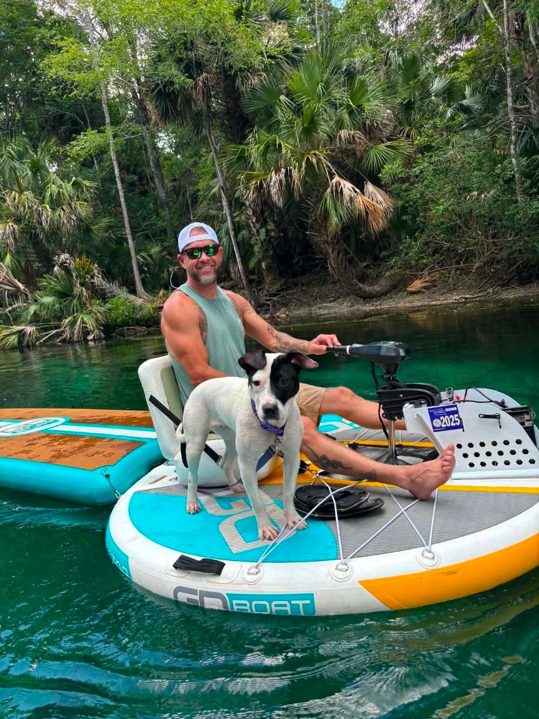 Rider and his dog aboard an electric GoBoat on Florida's clear spring water